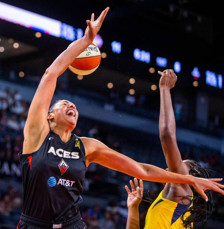 Las Vegas Aces center Liz Cambage, left, is fouled while driving to the basket by Indiana Fever ...