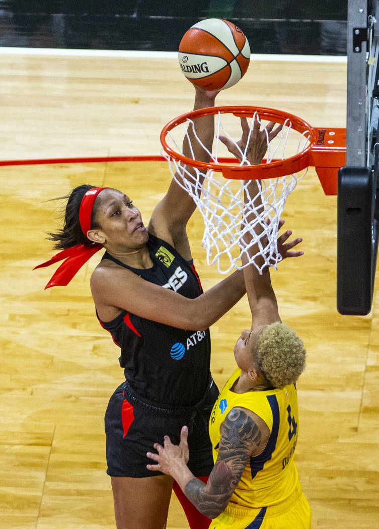 Las Vegas Aces forward A'ja Wilson (22) lays in a shot over Indiana Fever forward Candice Dupre ...