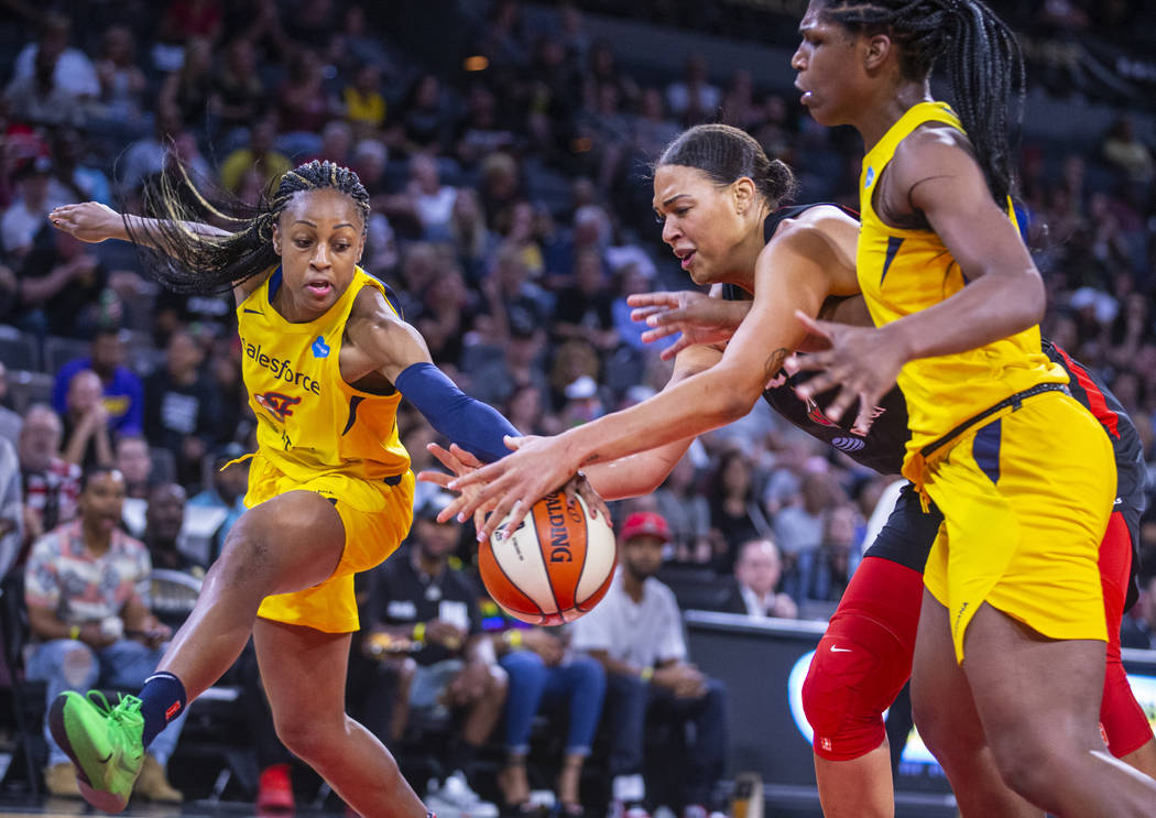 Indiana Fever guard Kelsey Mitchell, left, and Las Vegas Aces center Liz Cambage battle for a l ...