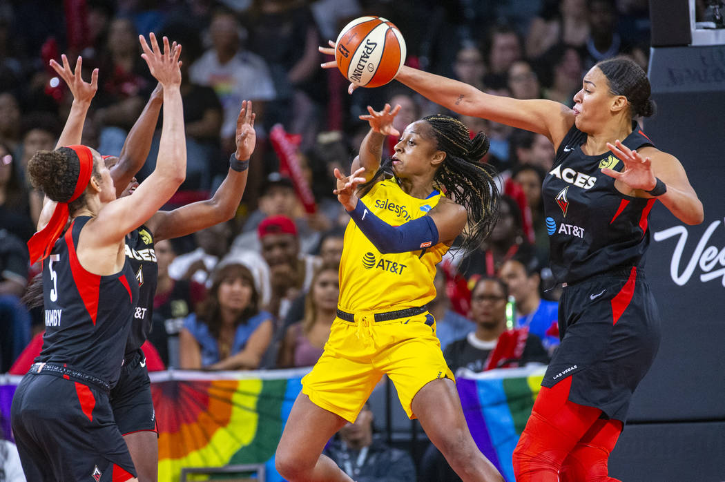 Indiana Fever guard Kelsey Mitchell (0) has a pass deflected by Las Vegas Aces center Liz Camba ...