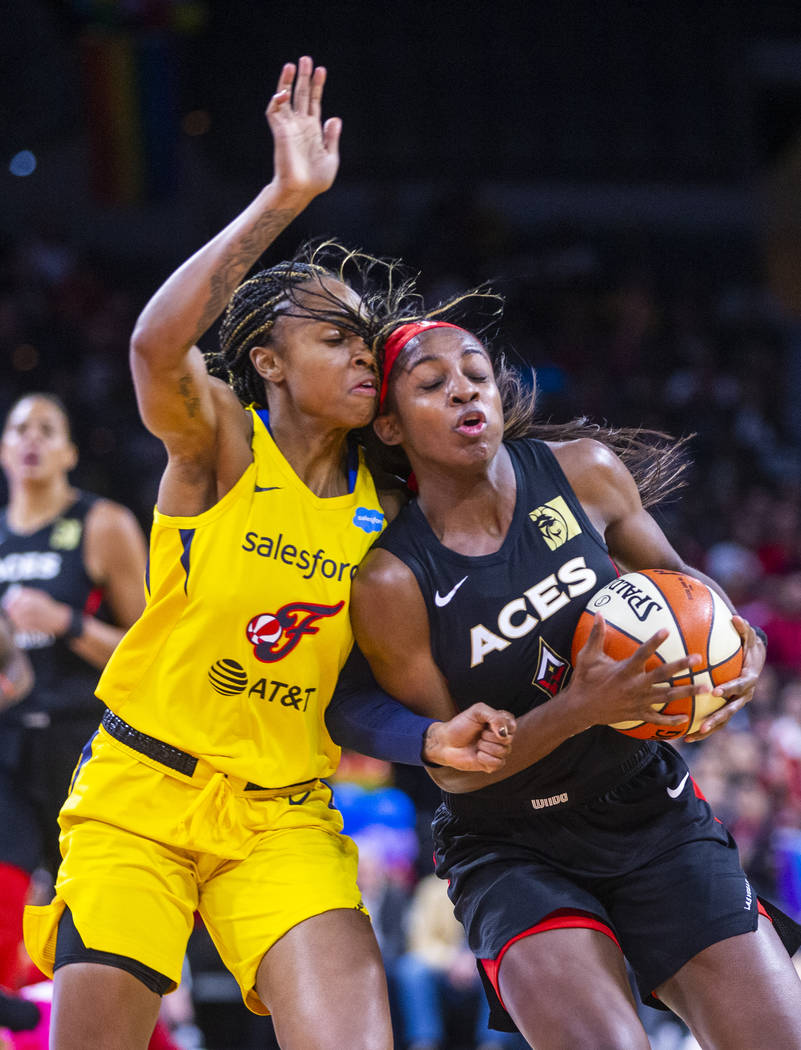 Indiana Fever guard Kelsey Mitchell (0) bodies up with Las Vegas Aces guard Sugar Rodgers (14) ...