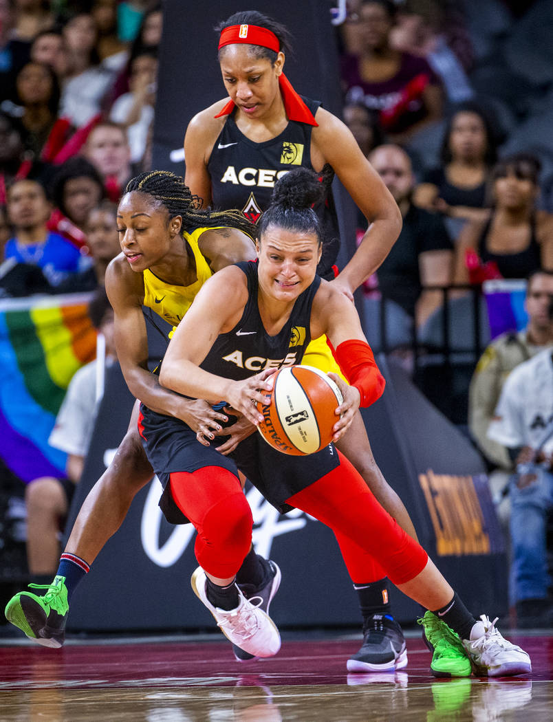 Las Vegas Aces guard Kayla McBride (21) is fouled from behind on a fast break attempt by Indian ...