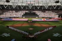 Boston Red Sox and New York Yankees players line up as flags are unfurled before a baseball gam ...