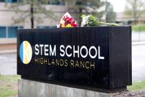 FILE - In this May 8, 2019 file photo bouquets of flowers sit on the sign outside the STEM Scho ...