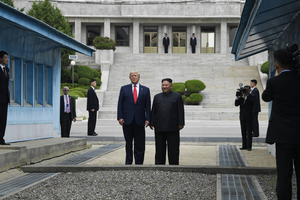 President Donald Trump and North Korean leader Kim Jong Un stand on the North Korean side in th ...