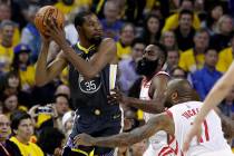 Golden State Warriors' Kevin Durant, left, is defended by Houston Rockets' James Harden, center ...