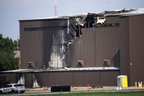 Damage is seen to a hangar after a twin-engine plane crashed into the building at Addison Airpo ...