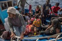 Migrants rest after being rescued at sea by the Open Arms aid boat on Sunday June 30, 2019. A h ...