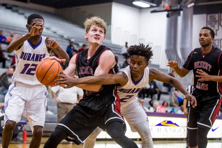 Desert Oasis’ Jacob Heese (15) looks for a shot as Durango’s Drake Booker (2) tr ...