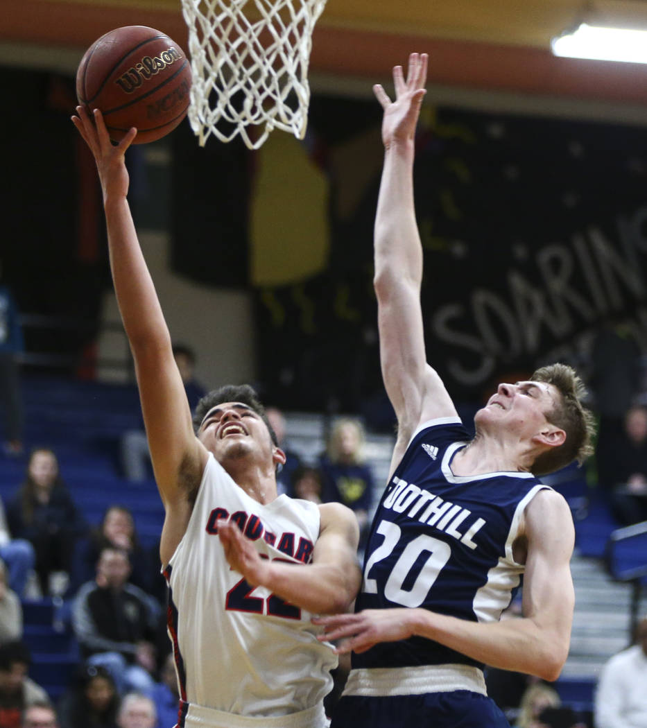 Coronado’s Patrick Simms (22) goes to the basket against Foothill’s Caleb Stearm ...