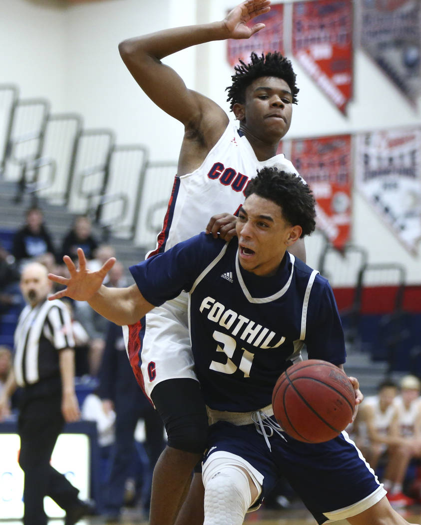 Foothill’s Marvin Coleman (31) drives against Coronado’s Jaden Hardy (1) during ...