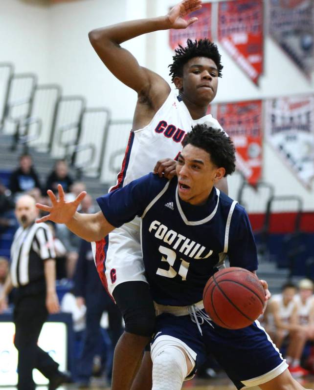 Foothill’s Marvin Coleman (31) drives against Coronado’s Jaden Hardy (1) during ...