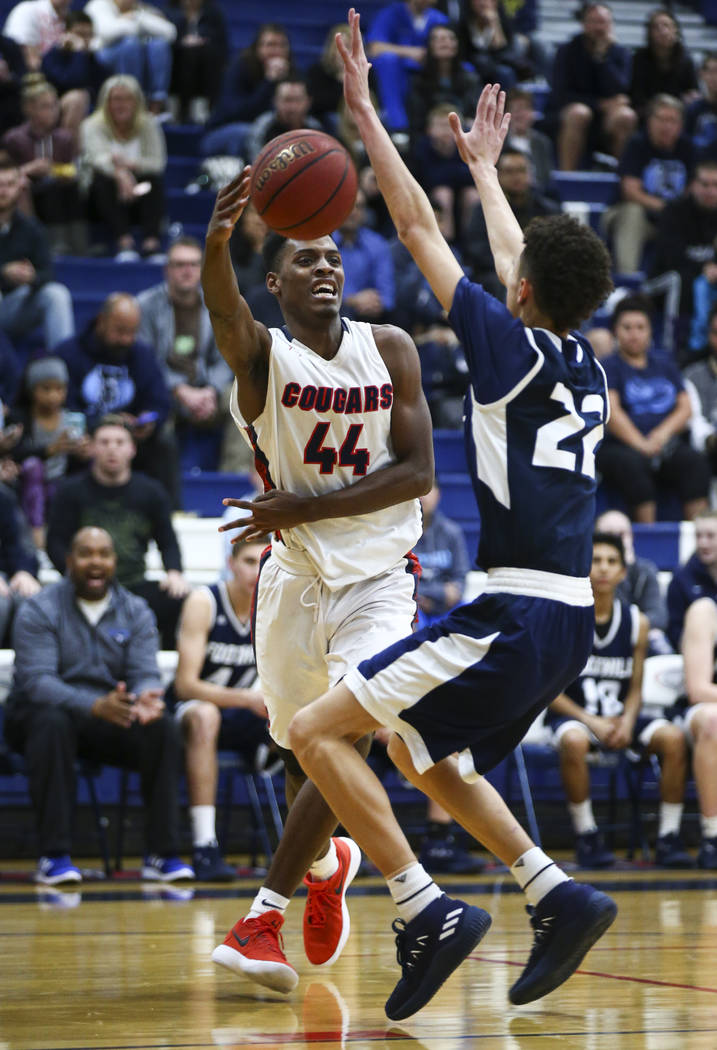 Coronado’s Taieem Comeaux (44) passes the ball around Foothill’s Jace Roquemore ...