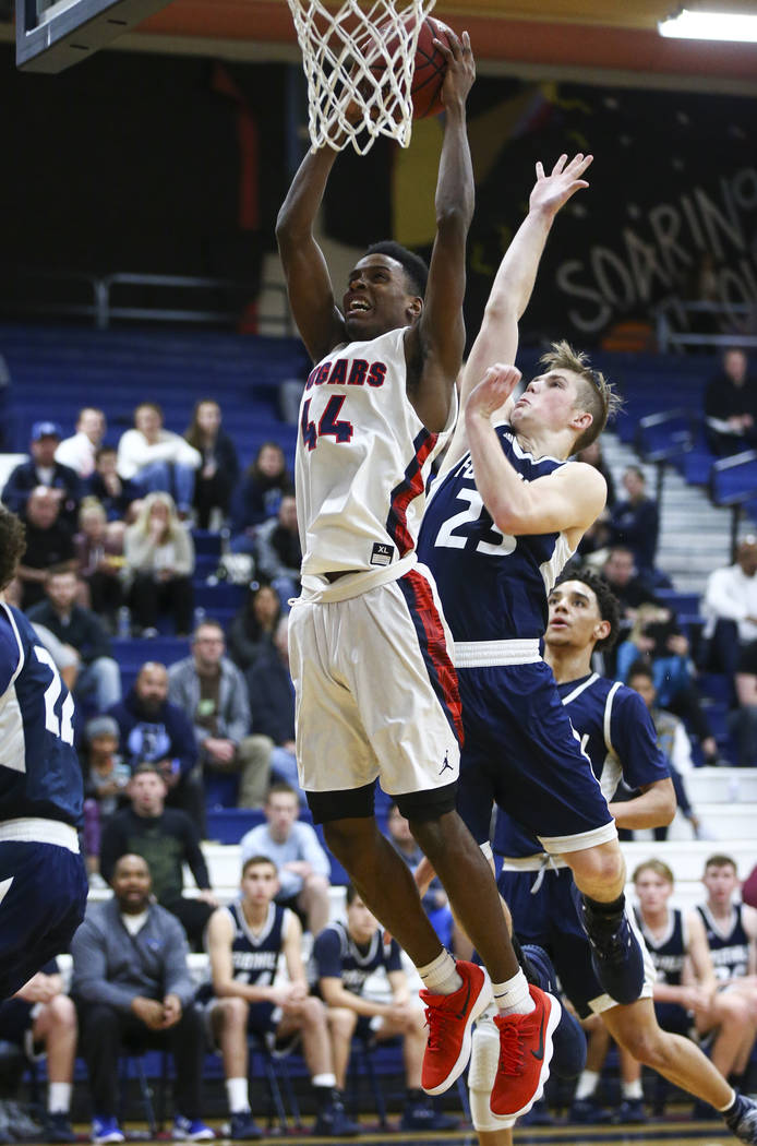 Coronado’s Taieem Comeaux (44) goes to the basket past Foothill’s Mike Shaw (23) ...