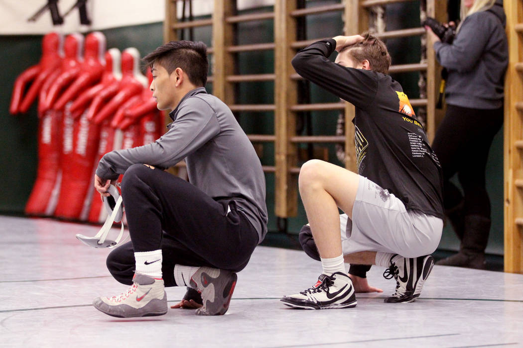 Green Valley High School junior wrestler Steele Dias, left, takes instruction with his train ...