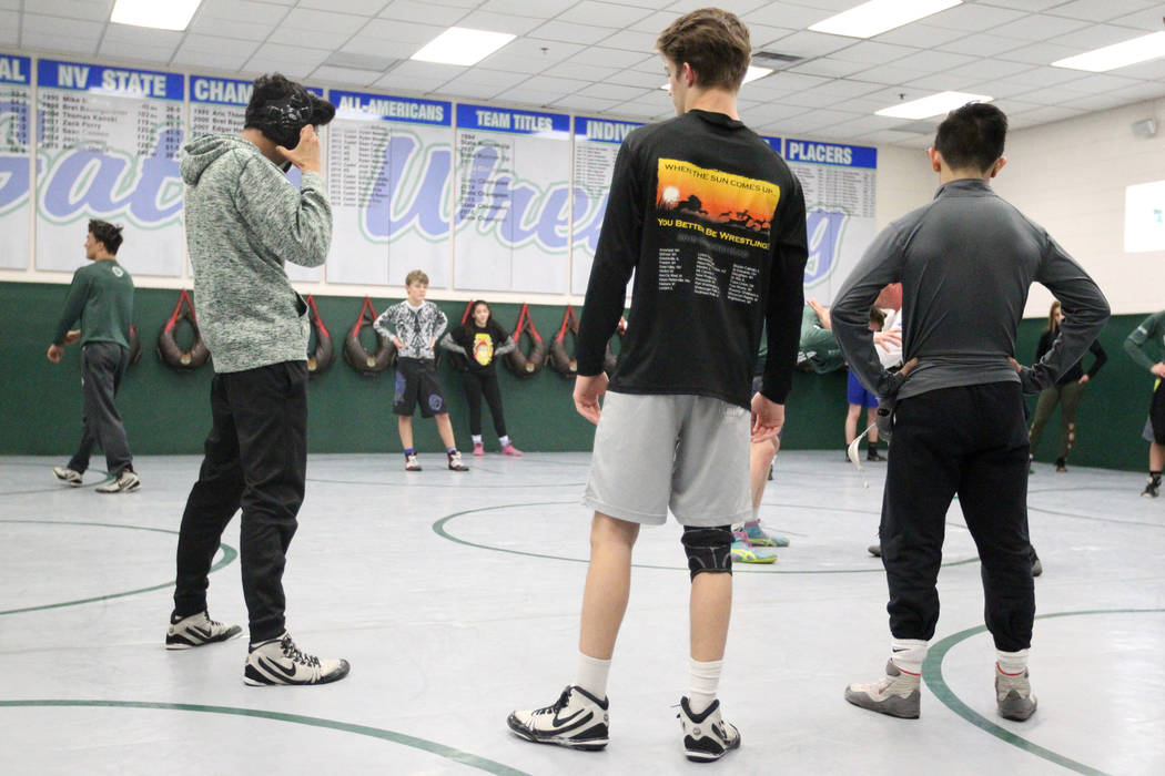 Green Valley High School junior wrestler Steele Dias, right, takes instruction with his trai ...