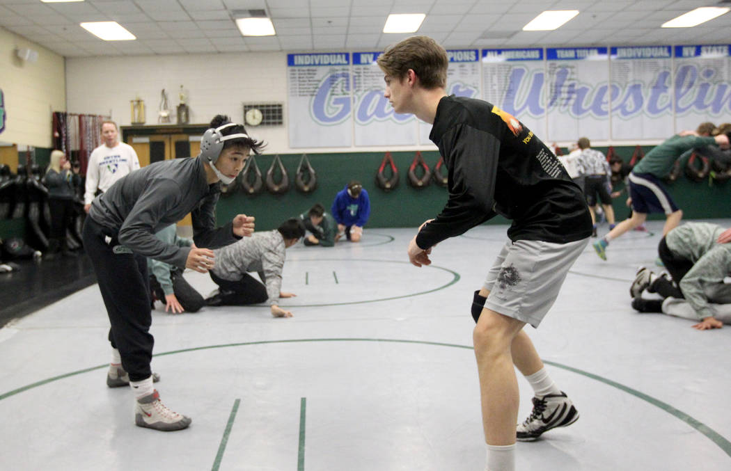 Green Valley High School junior wrestler Steele Dias, left, squares off with his training pa ...