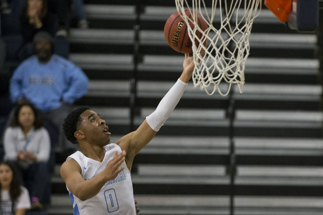 Centennial’s Ishon Hardin (0) goes up for a lay up against Arbor View in the Basketbal ...