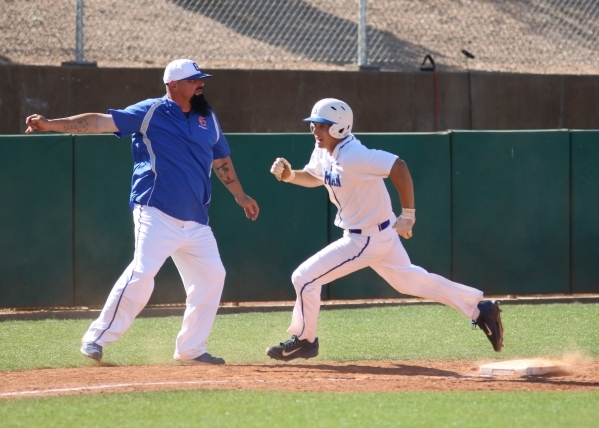 Bishop Gorman baserunner Grant Robbins is waved home by coach Gino DiMaria during a Sunset R ...