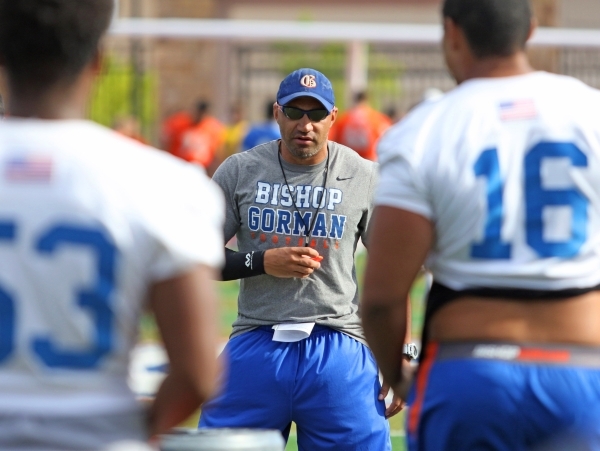 Bishop Gorman coach Kenny Sanchez runs offensive drills with the football team at Bishop Gor ...