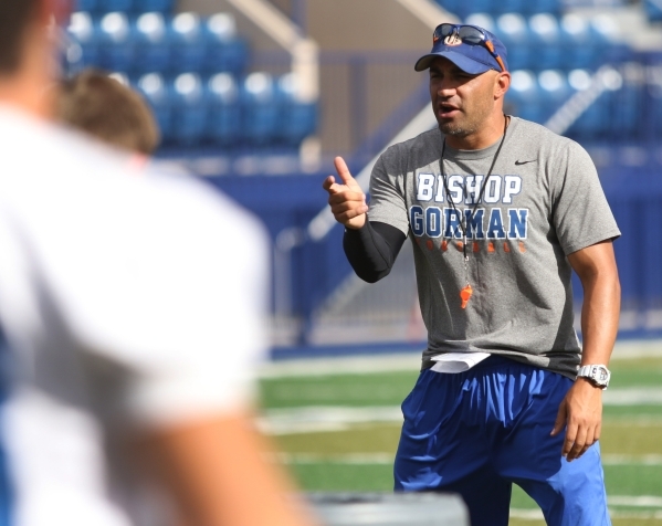 Bishop Gorman coach Kenny Sanchez runs offensive drills with the football team at Bishop Gor ...