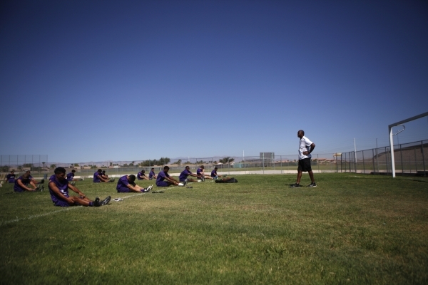 Randall Cunningham, Silverado High School head football coach, looks on at his players durin ...