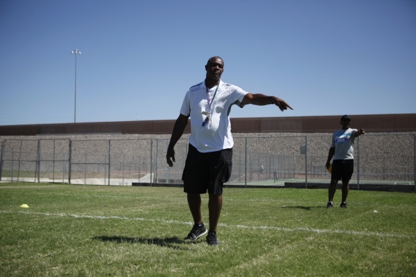 Randall Cunningham, Silverado High School head football coach, gives directions during pract ...