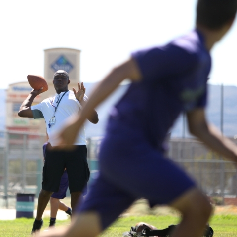 Silverado High School football coach Randall Cunningham throws during practice Monday. ...
