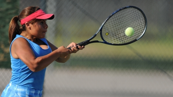 Senior Ashley Palacios, Desert Pines‘ No. 1 singles player, hits a backhand return dur ...