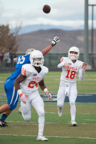 Bishop Gorman‘s Tate Martell (18) throws a pass down field against the Raiders during ...
