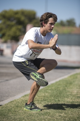Green Valley High School senior Austin Rogers, 16, stretches during cross country practice a ...