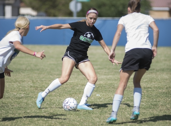 Green Valley High School junior Alexis Kirson, center, scrimmages with teammates Monday in H ...