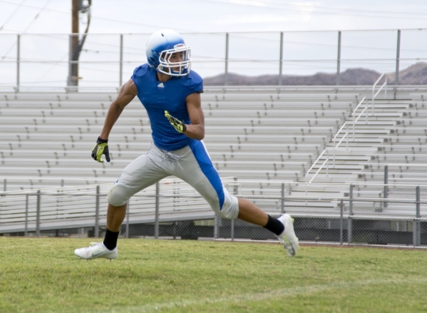 Basic defensive back Brian Evans sprints downfield while keeping his eyes on the ball during ...