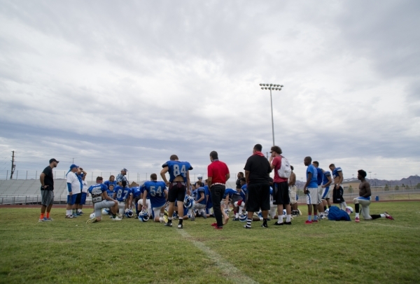 The Basic High School football team listens as coach Jeff Cahill gives some closing remarks ...