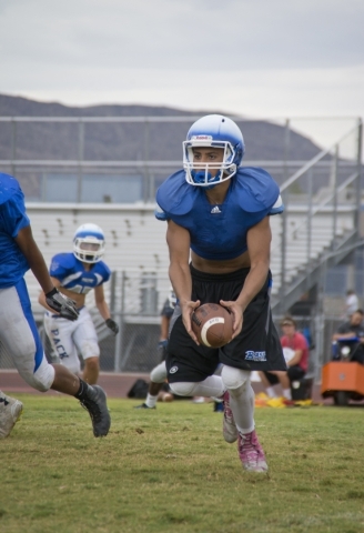 Basic quarterback Aeneas "Tank" McAllister prepares to hand off the football durin ...