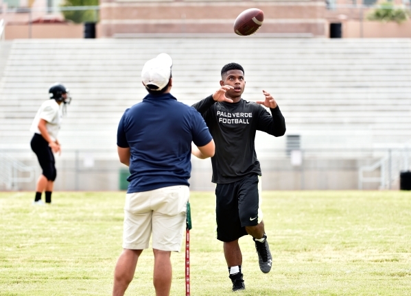 Palo Verde running back Aaron Chisolm, right, plays catch as he recovers from a sprained ank ...