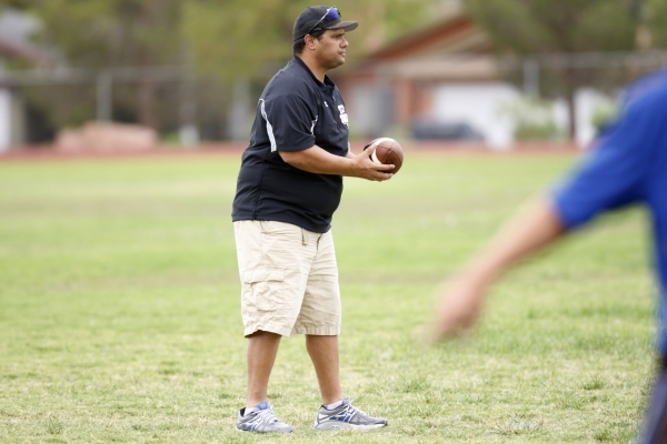 Desert Pines head football coach Tico Rodriguez stands on the field during practice at Deser ...