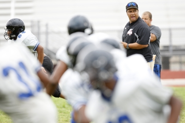 Desert Pines head football coach Tico Rodriguez stands on the field during practice at Deser ...