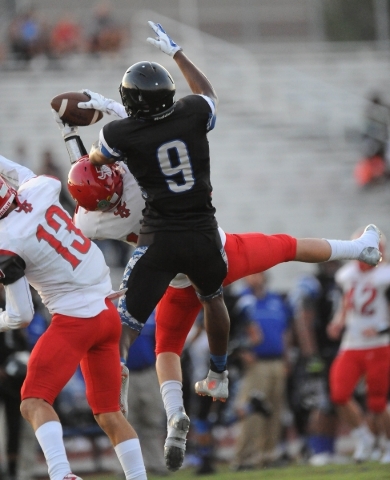 Arbor View defensive back Noah Noce, middle, intercepts a pass intended for Desert Pines wid ...