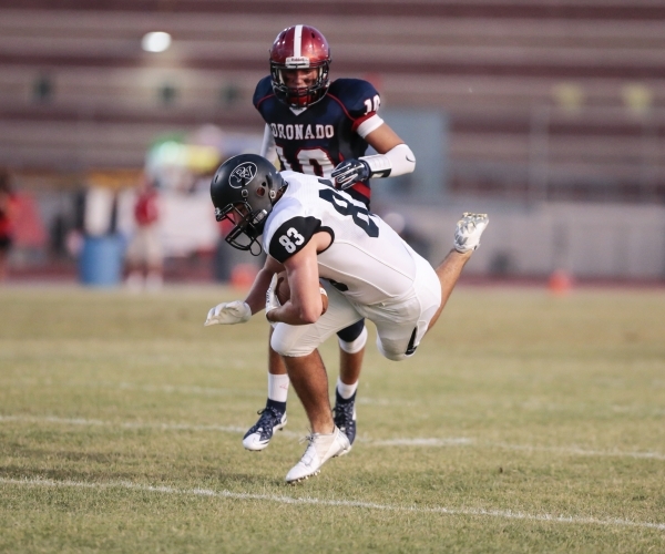 Palo Verde High School Senior Eric Taylor (8) stumbles with the ball while being chased by C ...