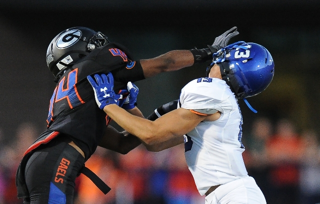 Bishop Gorman defensive back Brendan Radley-Hiles (44) tussles with Chandler wide receiver T ...