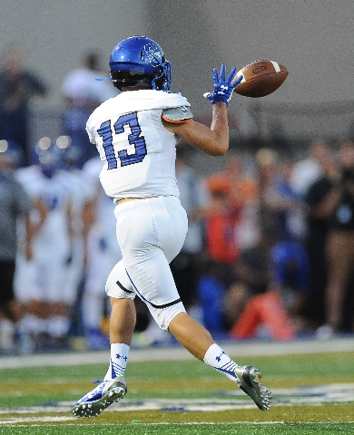 Chandler wide receiver Taj De Carriere catches a pass in the first quarter of their high sch ...