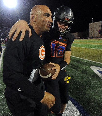 Bishop Gorman head coach Kenny Sanchez and starting quarterback Tate Martell embrace after t ...