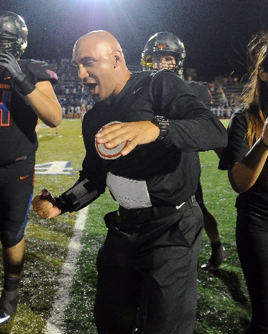 Bishop Gorman head coach Kenny Sanchez celebrates his first win as head coach of Bishop Gorm ...