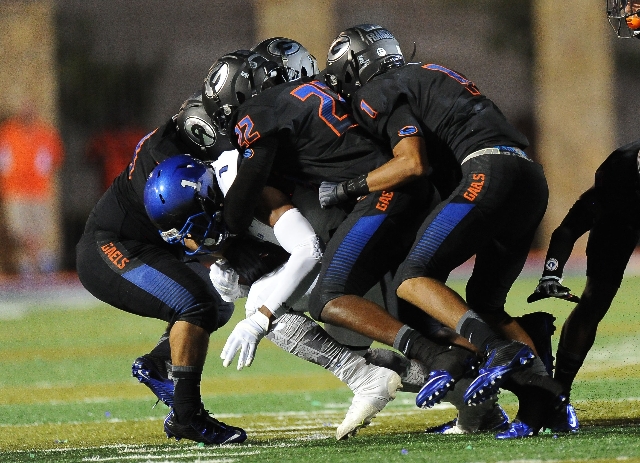 Bishop Gorman defense wrap up Chandler wide receiver N‘keal Harry (1) in the second qu ...