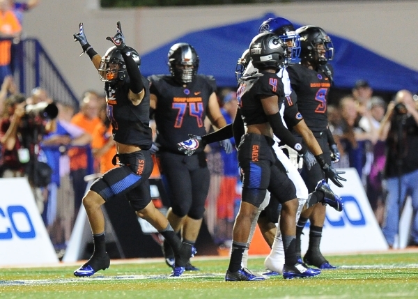 Bishop Gorman safety Damuzhea Bolden, left, and teammates celebrate a Chandler fumble in the ...