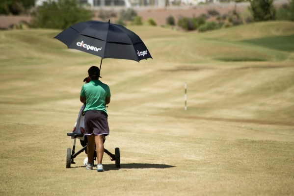 Aubrianna Jordan, a member of the Rancho High School golf team, pushes her bag down the cour ...