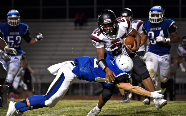 Basic‘s Kyle Grismanauskas (2) dives for the tackle against Desert Oasis‘ Ty&lsq ...