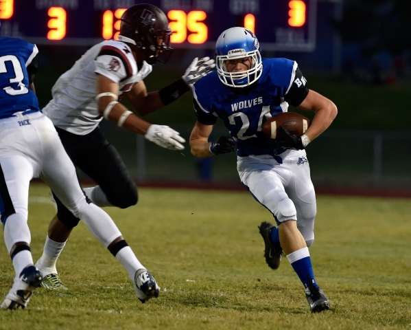 Basic&lsquo;s Alexander Holm (24) runs against Desert Oasis&lsquo; Branden Peterson during t ...