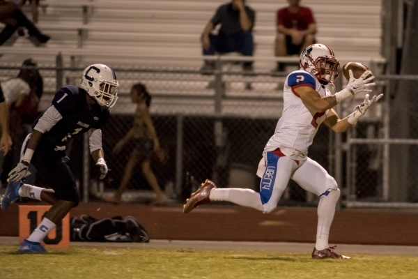Liberty Patriots wide receiver Ethan Dedeaux (2) bobbles the ball as Centennial Bulldogs def ...